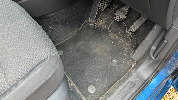 VW Touran driver's footwell before interior detailing in St Ives, Cambridgeshire